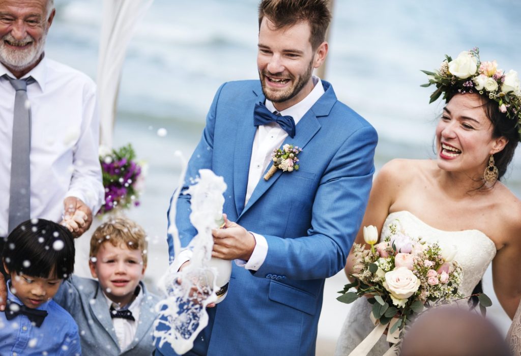 young-couple-in-a-wedding-ceremony-at-the-beach-e1630316228823.jpg